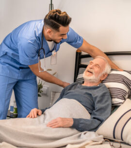 Experienced nurse positioning the patient in bed
