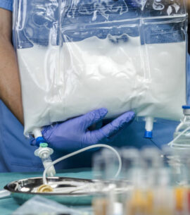 Nurse preparing medication for parenteral nutrition in a hospital, conceptual image