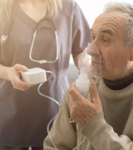 Elderly Senior Man nursing care wear oxygen inhaler device for helping breath respiratory. Oxygen Concentrator portable
