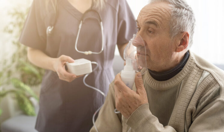 Elderly Senior Man nursing care wear oxygen inhaler device for helping breath respiratory. Oxygen Concentrator portable