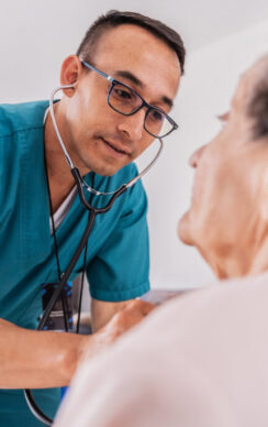 Nurse listening heartbeat of a senior woman during medical consultation