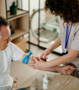 Nurse is taking a patient's blood