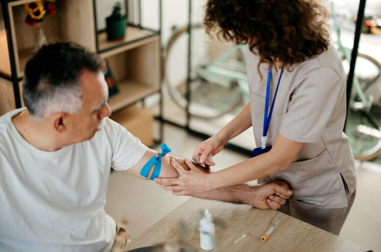 Nurse is taking a patient's blood